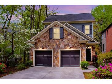 Charming home featuring a stone facade, two-car garage, and a beautifully landscaped front yard at 1048 Standard Ne Dr, Brookhaven, GA 30319
