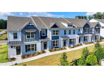 Charming new townhomes with brick facades, manicured lawns, and colorful architectural details at 2478 Honey Way, Conyers, GA 30013