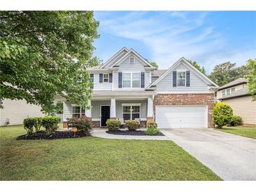 Charming two-story home with well-manicured lawn, landscaped flowerbeds and attached two-car garage at 4440 Spring Mtn Ln, Powder Springs, GA 30127