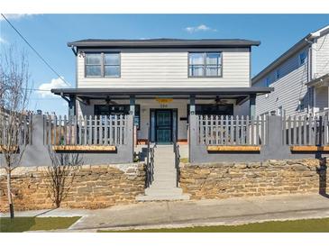Charming two-story home with a welcoming front porch and attractive curb appeal at 230 Woodward Se Ave, Atlanta, GA 30312