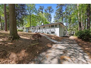 Sprawling single Gathering home with a driveway leading up to a well-maintained front yard at 964 Crane Ne Rd, Atlanta, GA 30324