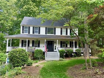 Charming two-story home with a welcoming front porch and well-manicured landscaping at 57 Glenn Eagles Way, Hiram, GA 30141
