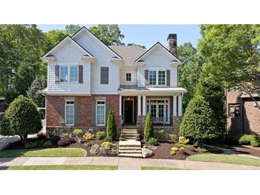 Charming two-story home with brick and stone accents, beautiful landscaping, and a welcoming front porch at 4675 Lakeway Pl, Alpharetta, GA 30005