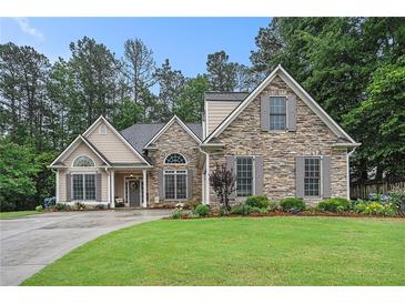 Charming home with stone and siding exterior, manicured lawn, and inviting front porch at 40 Templeton Ln, Villa Rica, GA 30180