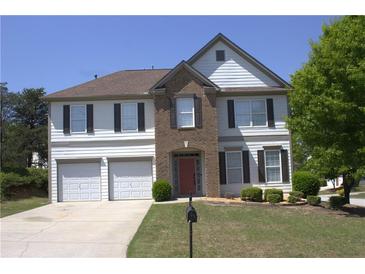 Traditional two-story home with a well-manicured lawn, two-car garage and neutral color palette at 3152 Spruce Way, Atlanta, GA 30349