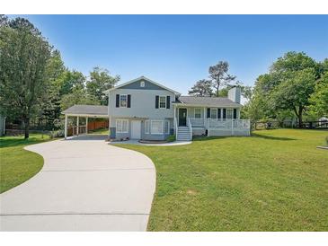 Charming two-story home featuring a spacious yard, attached carport, and inviting front porch at 3009 Bruce Nw Ct, Acworth, GA 30101