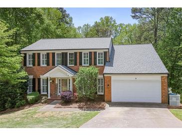 Traditional brick home with black shutters, white trim, and a well-manicured lawn at 2794 Kakki Ct, Marietta, GA 30062