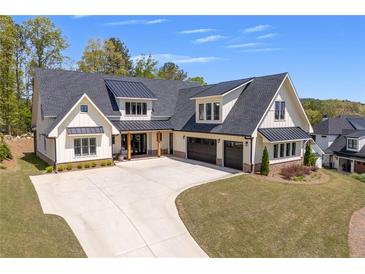 Stunning exterior of home with a dark metal roof, white siding, an extended driveway and a two car garage at 247 Terrace View Dr, Acworth, GA 30101
