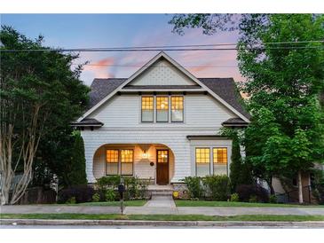 Charming two-story home featuring an arched front porch and beautifully landscaped front yard at 248 Madison Ave, Decatur, GA 30030