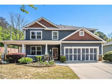 Charming two-story home featuring a welcoming front porch and a well-maintained, landscaped front yard at 1699 Boulder Walk Se Dr, Atlanta, GA 30316