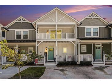 Charming townhome with double balconies and a welcoming front porch, perfect for enjoying outdoor living at 14020 Tributary Ln, Villa Rica, GA 30180