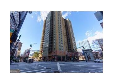 View of the building from the street showing its height and urban location at 300 Peachtree Ne St # 5A, Atlanta, GA 30308