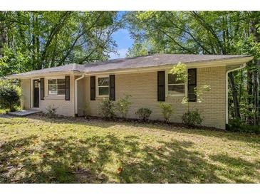 Charming brick home with mature trees and lovely landscaping offers great curb appeal at 3693 Larkspur Ter, Decatur, GA 30032