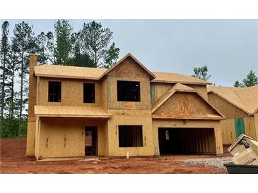 Unfinished exterior view of a two-story home with a two-car garage and wood-frame construction at 488 Charleston Pl, Villa Rica, GA 30180