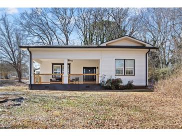 Charming single-story home featuring a covered front porch with traditional architectural details at 3595 South Nw St, Duluth, GA 30096