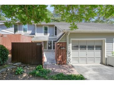 Charming townhouse featuring a garage, fenced courtyard, and lovely landscaping at 5058 Meadow Ne Ln, Marietta, GA 30068