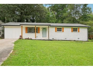 Charming brick ranch-style home featuring a well-manicured lawn and inviting curb appeal at 2450 Elkhorn Dr, Decatur, GA 30034