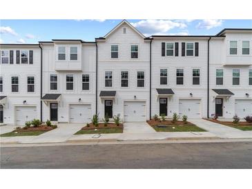Charming townhomes with white siding, black shutters, and one-car garages offer stylish curb appeal at 3149 Washburn Sw St, Atlanta, GA 30354