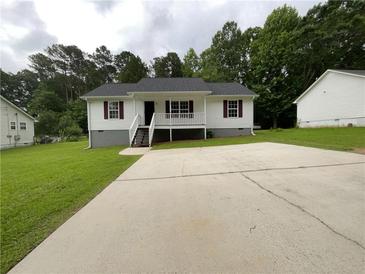 Charming single-story home with white siding, red shutters, and a spacious concrete driveway at 45 Carroll St, Temple, GA 30179