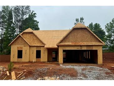 Exterior of new construction home shows the framing and garage; awaiting finishing and personalization at 490 Charleston Pl, Villa Rica, GA 30180