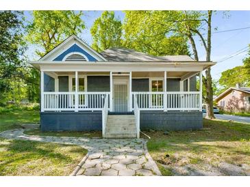 Charming single-story home with a welcoming front porch and landscaped walkway at 1290 Campbellton Sw Rd, Atlanta, GA 30310