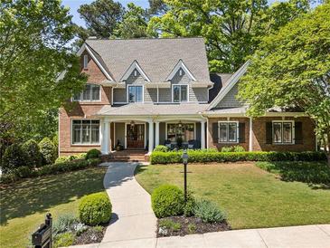 Charming two-story home with a beautifully landscaped front yard and a welcoming entrance at 1050 Signal Pointe, Alpharetta, GA 30005