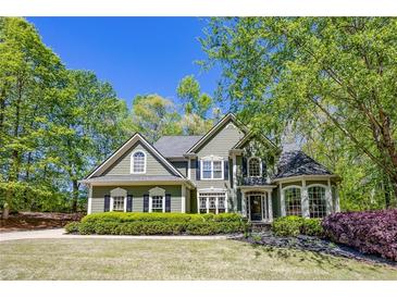 Charming two-story home with lush landscaping, a well-maintained lawn, and classic architectural details at 402 Glenhurst Trce, Canton, GA 30115