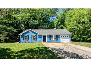 Charming blue home with a well-manicured lawn and a single-car garage at 685 Greenhedge Dr, Stone Mountain, GA 30088