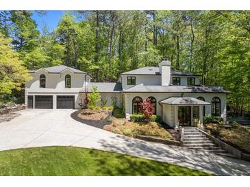 Stunning home exterior with manicured lawn, driveway, and attached garage at 4067 Randall Farm Se Rd, Atlanta, GA 30339