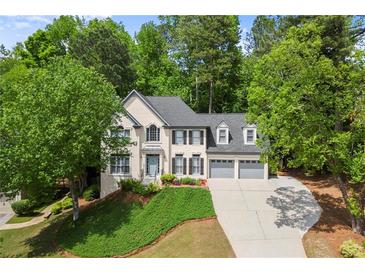 Charming two-story home with well-maintained landscaping and a three-car garage at 11060 Pennbrooke Xing, Johns Creek, GA 30097