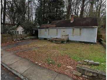 Modest single-story home with boarded windows, awaiting restoration and transformation at 1254 Campbellton Sw Rd, Atlanta, GA 30310