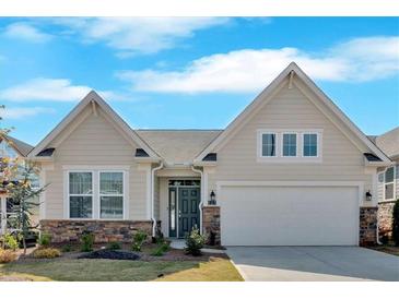 Charming single-story home featuring stone accents, a two-car garage, and well-maintained landscaping at 127 Laurel Farms Ln, Dallas, GA 30157