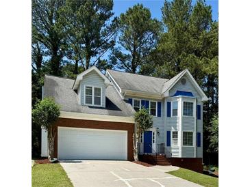 Charming two-story home with a brick-accented garage and blue shutters at 2875 Riverbend Ct, Snellville, GA 30078