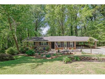 Charming brick home with a well-manicured lawn and beautiful landscaping at 3139 Mary Dr, Marietta, GA 30066