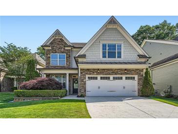 Charming two-story home with stone accents, manicured landscaping, and an attached two-car garage at 3699 School Street, Chamblee, GA 30341