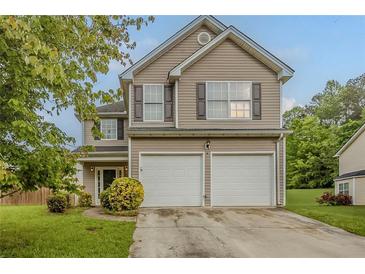 Charming two-story home with a two-car garage, neutral siding, and well-maintained landscaping at 4139 Kensington Cv, Atlanta, GA 30349