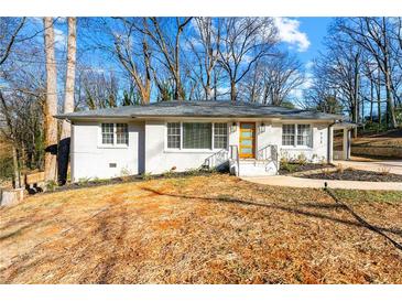 Charming, freshly painted single-story home with a welcoming front yard and minimalist landscaping at 932 Mount Airy Sw Dr, Atlanta, GA 30311