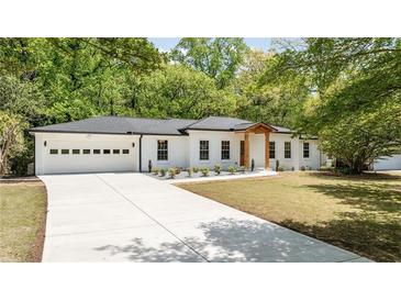 Charming renovated ranch-style home with white brick, black trim, new driveway and two car garage at 2327 Doreen Ne Ct, Atlanta, GA 30345