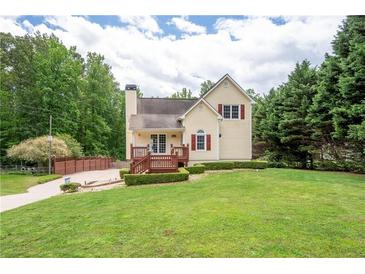 Charming two-story home with a well-manicured lawn, a cozy front porch, and mature trees at 96 Grover Way, Dallas, GA 30157
