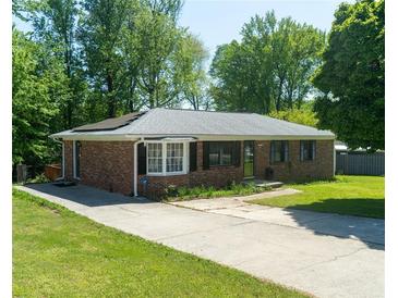 Charming brick home with a well-maintained lawn and driveway at 724 Camelot Way, Norcross, GA 30071