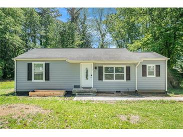Charming single-story home featuring gray siding, black shutters, and a welcoming front door at 4135 Brenda Dr, Decatur, GA 30035