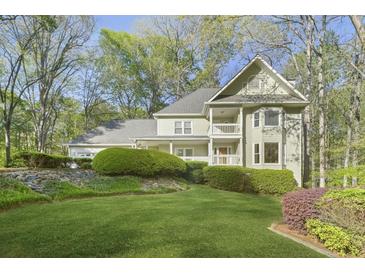 Charming two-story home with well-manicured lawn and lush landscaping at 1488 Rivermist Sw Dr, Lilburn, GA 30047