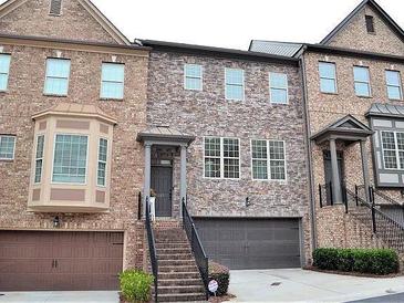 Charming brick townhome with stone accents, inviting entrance, and attached two-car garage at 1032 Willow Field Se Ln # 17, Marietta, GA 30067