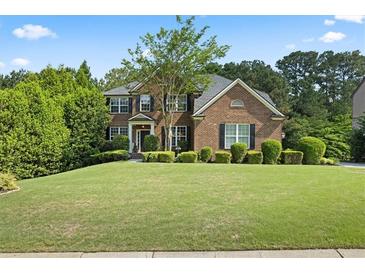Well-manicured lawn and landscaping enhance this two-story brick home's curb appeal at , Cumming, GA 30041