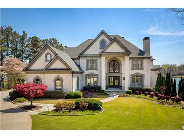 Stunning two-story brick home with manicured lawn and mature landscaping at 1160 Lake Shore Overlook, Alpharetta, GA 30005