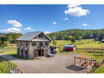 Striking barn home featuring a full guest house and an abundance of land in a picturesque setting at 96 Landers Ne Rd, Rydal, GA 30171