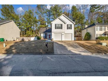 Charming two-story home with a two car garage and well-maintained front yard in a suburban neighborhood at 939 Redan Trce, Stone Mountain, GA 30088