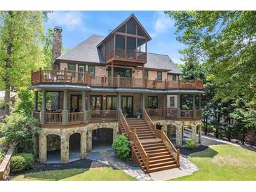 Stunning multi-story home boasts multiple decks, stone accents, and outdoor access at every level at 4290 Bobbins Way, Cumming, GA 30041