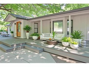 Inviting front porch featuring stylish outdoor seating, decorative plants, and a warm, welcoming entrance at 7580 Blacks Mill Rd, Cumming, GA 30028