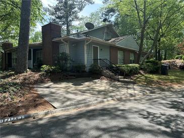 Charming home featuring a brick chimney, landscaped yard, and ample parking at 4828 Westridge Dr, Norcross, GA 30093